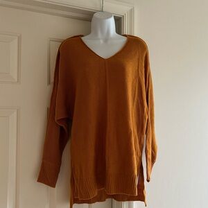 Orange v-neck sweater with slits on sides
